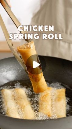 a person is frying some food in a skillet with the words chicken spring roll