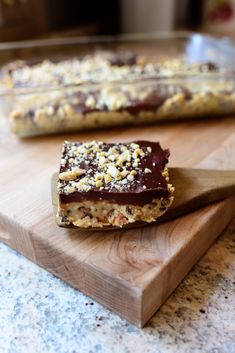 two pieces of food sitting on top of a wooden cutting board