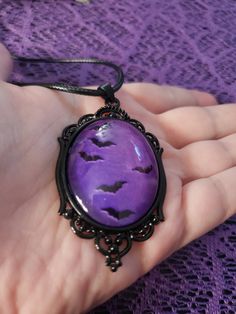 This gothic/victorian style necklace features a black frame and a purple interior. The bats appear to be flying. Perfect necklace for anyone who loves gothic jewlery! The pendant lays on a black waxed adjustable necklace cord and is 20" long. 2.48"×1.46" *size is approximate* *one sided* Gothic Purple Jewelry For Halloween, Gothic Purple Necklace For Halloween, Bat Pendant, Hex Girls, Bat Necklace, Purple Interior, Gothic Victorian, Necklace Cord, Victorian Gothic