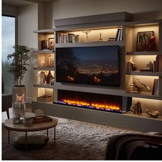 a living room with an entertainment center and fire place in the wall that is lit up