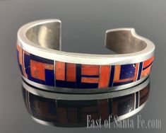 There are some artists who work needs almost no introduction.  Ray Tracey is one of those artists.  His designs, quality of stone, and precision inlay are unmistakeable.  It's just some of the best and tightest inlay out there!  This cuff is inlaid end to end with rich red coral and blue lapis.  It's signed with Ray Tracey's knifewing hallmark and sterling. Please double check your wrist measurement.  This is a heavy and well made bracelet.  As with almost all inlay, it cannot be adjusted or resized in any way.  Measurements The inside circumference measures  5 1/4" plus the gap opening of 1" for a total of 6 1/4" Happy to answer any questions Ray Tracey Jewelry, Coral And Blue, Blue Lapis, Red Coral, The Gap, Cuff Bracelet, Hallmark, Native American, Cuff Bracelets