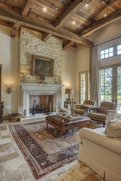 a living room with couches, chairs and a fire place in it's center