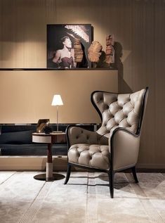 a living room filled with furniture next to a painting on the wall above a coffee table