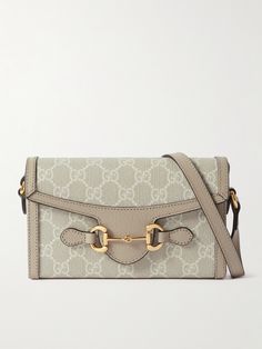 Gucci's bag is part of the label's 'Horsebit 1955' collection, which pays tribute to archival signatures including the equestrian hardware and 'GG' monogram. Made in Italy, it has a compact, structured coated-canvas silhouette outlined in beige leather and a canvas-lined interior sized to fit just the essentials. Adjust the shoulder strap to wear it cross-body. Gucci Travel Bag With Horsebit Detail, Vintage Shoulder Bag With Horsebit Detail For Everyday, Vintage Shoulder Bag With Horsebit Detail, Beige Travel Bag With Horsebit Detail, Classic Beige Bag With Horsebit Detail, Classic Beige Bags With Horsebit Detail, Classic Beige Shoulder Bag With Horsebit Detail, Vintage Rectangular Shoulder Bag With Horsebit Detail, Vintage Leather Bags With Horsebit Detail