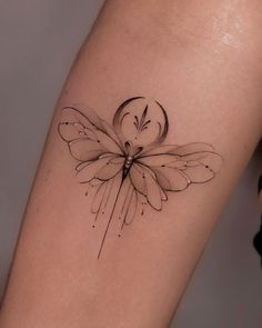 a small tattoo on the leg of a woman's thigh with a flower and heart