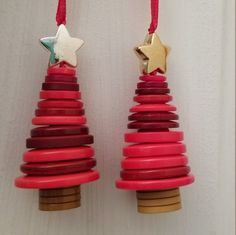 two wooden christmas trees hanging from red string