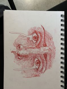 a drawing of an eye is shown in red ink