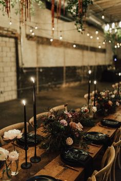 a long table with candles and flowers on it