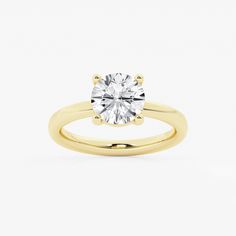 a yellow gold engagement ring with a round diamond in the center, on a white background