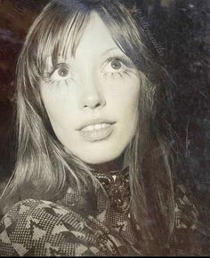 a black and white photo of a woman with long hair