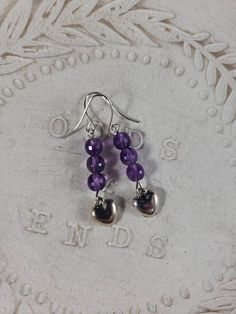 Handmade earrings purple beads are are glass, silver hearts dangle at bottom, so adorable. Handmade Purple Heart Dangle Earrings, Handmade Purple Dangle Heart Earrings, Nickel-free Purple Sterling Silver Beaded Earrings, Handmade Purple Heart Earrings Gift, Handmade Purple Heart Earrings For Gift, Purple Heart Beads Earrings For Gift, Handmade Purple Earrings For Valentine's Day, Sterling Silver Heart Beads Dangle Earrings, Purple Sterling Silver Beaded Dangle Earrings