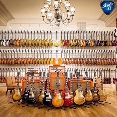 guitars are lined up on display in a music store