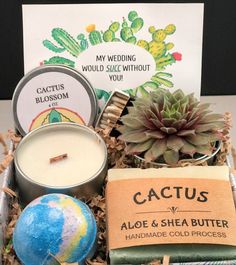 an assortment of candles, soaps and other items in a tin with a card