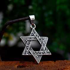 Celebrate heritage and faith with the Star Emblem Necklace. This striking pendant features a meticulously crafted hexagram, known as the Star of David, rendered in a sleek stainless steel Amulet. The timeless design embodies centuries of Jewish tradition and spirituality, creating a powerful symbol of identity and protection. Suitable for everyday wear, this necklace serves as a meaningful accessory or a thoughtful gift. Let this elegant piece be your daily connection to cultural roots and personal strength. Iconic hexagram design Durable 316L stainless steel Retro Chain Included (24 inch length) Meaningful Jewish symbolism Pendants For Men, Celtic Knot Pendant, Engraved Flower, Jewelry Words, Things Under A Microscope, Skull Fashion, Vintage Punk, Skull Pendant, Mens Pendant