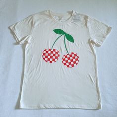 Brand New With Tags Grayson Threads Double Checkerboard Cherries Graphic Tee Excellent Condition With No Flaws Size Junior Medium 60% Cotton 40% Polyester Approx Measurements Laying Flat: Length 25.5" Armpit To Armpit 19" Across Bottom Hem 20" Color Of Tee Is A Light Cream With Double Red And White Checkerboard Cherries Graphic In Front Cherries Graphic Has An Intentional Distressed Look Crew Neck, Short Sleeves, Straight Hem Note: Last Photo Is A Stock Photo Please No Trades Or Lowballs! *Ask A Casual White Cherry Print Tops, Crew Neck Graphic Tee With Cherry Print, Cherry Print Crew Neck Graphic Tee, Crew Neck Cherry Print Graphic Tee, Cotton T-shirt With Cherry Print And Crew Neck, Cotton Crew Neck T-shirt With Cherry Print, White Short Sleeve Top With Cherry Print, Cotton Cherry Print Crew Neck T-shirt, White Cherry Print Short Sleeve Top