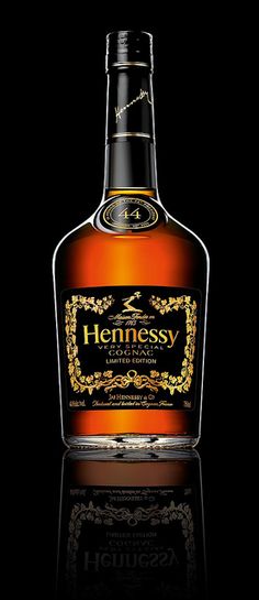 a bottle of hennessy whisky on a black background