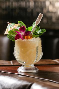 a drink with flowers in it sitting on a table