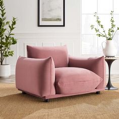 a pink chair sitting on top of a rug