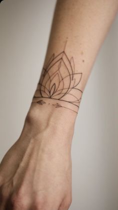 a person's arm with a tattoo on it that has a flower in the middle