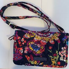 Vera Bradley Rfid All In One Crossbody Bag Like New. Unused, Clean Condition. No Stains Or Holes. Navy Blue With Pink, Purple, Yellow, And Green Flowers. One Snap Pocket And Two Zipper Pockets. Water-Repellent Polyester. 8 Card Slips, 4 Slip Pockets, 1 Bill Pocket. Dimensions: 6.75” Width X 3.75” Height X 2.25” Depth With 56” Removable, Adjustable Strap. Versatile Multicolor Bag With Cell Phone Pocket, Multicolor Rfid Blocking Bags For Daily Use, Multicolor Daily Use Bags With Rfid Blocking, Rfid Blocking Crossbody Bag For Everyday Use, Versatile Multicolor Bags With Cell Phone Pocket, Multicolor Rfid Blocking Travel Bag, Casual Bags With Rfid Blocking For On-the-go, Casual Rfid Blocking Bag For On-the-go, Yellow And Green Flowers