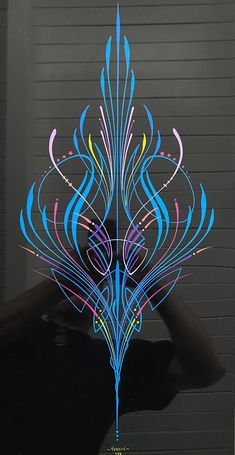 a person standing in front of a garage door with an artistically designed design on it