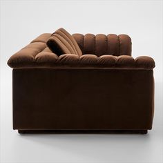 a brown couch sitting on top of a white floor