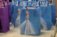 several bags with frozen princesses on them are sitting on a table in front of other bags