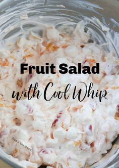 fruit salad with cool whip in a glass bowl on a wooden table top and text overlay that reads, fruit salad with cool whip