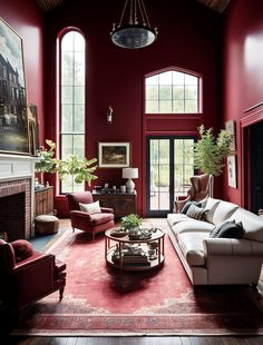 a living room with red walls and furniture