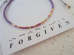 "This Morse Code bracelet spells out Forgiven in dots and dashes (Morse Code). What a great gift for the Christian in your life whether it's your best friend, your mom, your sister, your girlfriend, or yourself. It's made with fine nylon knotting cord and tiny Japanese Delica glass beads in a beautiful color combination with Gold spacers. The sliding knot makes the bracelet adjustable and easy to get on and take off. Great for yourself or gift giving. The bracelet adjusts from 5.5\" - 9\". If yo Gift Purple Beaded Bracelets With Sliding Knot, Purple Beaded Bracelets With Sliding Knot As Gift, Purple Friendship Bracelet With Tiny Beads As Gift, Purple Tiny Beads Friendship Bracelet As Gift, Spiritual Bracelets, Christian Bracelets, Colorful Bracelet, Morse Code Bracelet, Bracelet Minimalist