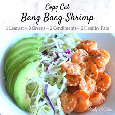 a white plate topped with shrimp and coleslaw next to an avocado