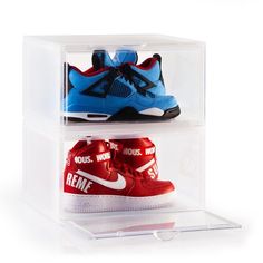 two pairs of shoes are in a clear box with red, blue and white sneakers