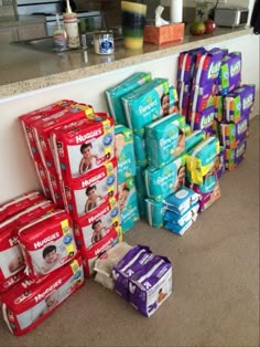 many diapers are stacked on the floor next to each other in front of a counter