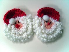 two crocheted santa claus slippers on a white surface