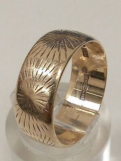 a gold ring sitting on top of a white surface