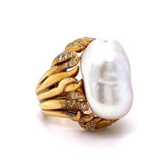 This Mid-Century inspired cocktail ring truly shines! A stunning Mabe pearl is the centerpiece of the ring, surrounded by forty (40) round brilliant cut diamonds. The diamonds measure 1.6 mm and weigh .018 carats each. This ring is sure to make a statement, whether you wear it for a night out or save it as a special heirloom. A timeless addition to any jewelry collection. Luxury Pearl Rings With Diamond Accents, Luxury Pearl Ring For Evening, Luxury Oval Pearl Ring, Luxury Pearl Ring With Rose Cut Diamonds For Anniversary, Diamond Cocktail Ring, Mabe Pearl, Diamond Cocktail Rings, Shop Engagement Rings, Pearl Diamond