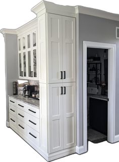 a kitchen with white cabinets and granite counter tops