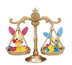 two pikachu figurines sitting on top of each other in a scale