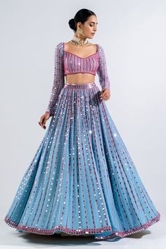 Ice blue lehenga with mirror embroidery in a stripe pattern and multicolor thread work. Comes with full sleeve blouse and border embroidered dupatta.
Components: 3
Pattern: Embroidery
Type Of Work: Mirror
Neckline: Sweetheart
Sleeve Type: Long
Fabric: Lehenga and Blouse- Georgette and Dupatta: Satin Organza
Color: Blue
Other Details: 
Low back with tie up and tassels
Dupatta with mirror embroidered border
Closure: Back hook
Note: Choker worn by the model is not for sale
Occasion: Sangeet - Aza F Light Blue Fitted Dress With Mirror Work, Light Blue Bollywood Lehenga In Georgette, Light Blue Georgette Bollywood Lehenga, Blue Party Wear Lehenga For Celebration, Fitted Light Blue Anarkali Set For Party, Blue Party Wear Choli For Festive Occasions, Blue Festive Party Wear Choli, Fitted Blue Sets With Mirror Work, Fitted Floor-length Light Blue Choli