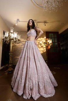 This dreamy powder pink lehenga is hand embroidered with all over sequin, crystals and cutdana embroidery. Paired with an embellished strappy blouse and matching dupatta.From Isa by Dolly Wahal's Fiori collection.DELIVERY TIMEPlease allow 8-12 weeks for your outfit to arrive.FABRIC DETAILSOrganza SilkProfessional cleaning only. Glamorous Lehenga With Resham Embroidery For Reception, Glamorous Pink Designer Wear Choli, Glamorous Lehenga With Intricate Embroidery For Reception, Pink Hand Embellished Party Wear Choli, Glamorous Pink Dress With Zari Work, Glamorous Hand Embellished Pink Choli, Pink Hand Embellished Glamorous Choli, Glamorous Pink Hand Embellished Choli, Pink Hand Embellished Party Choli