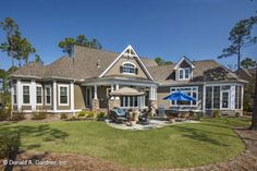 a large house with an umbrella in the front yard