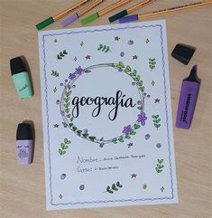 a card with the word geographia surrounded by paint and crayons