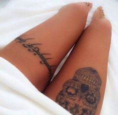 a woman's legs with tattoos on them