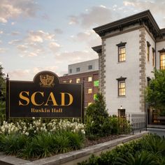 there is a sign that says scad in front of a building with many windows