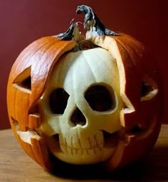 a pumpkin carved to look like a jack - o'- lantern with a skeleton inside