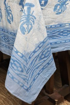 blue and white table cloths on wooden chairs