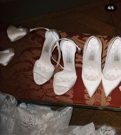 four pairs of white shoes sitting on top of a table