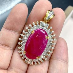 "This gorgeous, vivid, HUGE CABOCHON-Shaped, Burmese Ruby and stunning, impeccably graded F/VS Diamonds will totally melt everyone's heart! EXTREMELY RARE ENORMOUS 40.89 CARATS BURMESE RUBY with ATTRACTIVE, VIVID, HOT-PINKISH-RED color. SET IN FINE 18K SOLID YELLOW GOLD HANDCRAFTED PENDANT! ONLY ONE ITEM AVAILABLE!! WHAT YOU SEE IN THE PICTURES IS WHAT YOU WILL GET   \"You will get the best GEMSTONES from the most experienced GEMS wholesaler in the world.\" SUGGESTED RETAIL VALUE: $35,000 RUBY: Exquisite Ruby Jewelry Gia Certified, Dazzling Gia-certified Ruby Jewelry, Dazzling Gia Certified Ruby Jewelry, Luxury Red Cabochon Necklaces, Luxury Red Cabochon Necklace, Luxury Ruby Pendant Jewelry, Exquisite Red Cabochon Jewelry, Gia Certified Yellow Gold Necklace Gift, Ruby Cabochon Pendant Jewelry