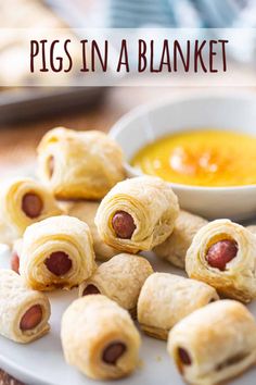 pigs in a blanket on a plate next to a bowl of dipping sauce with text overlay