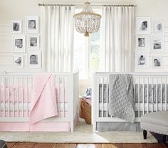 a baby's room with two cribs and pictures hanging on the wall